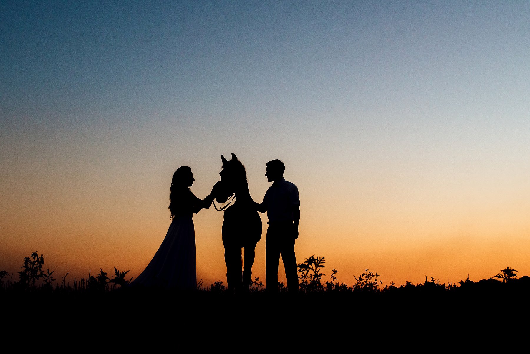 girl-guy-silhouette-sunset-with-horses-village.jpg